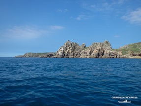 Kayak Fishing at Porthcurno - Looking towards Logan Rock on a calm day